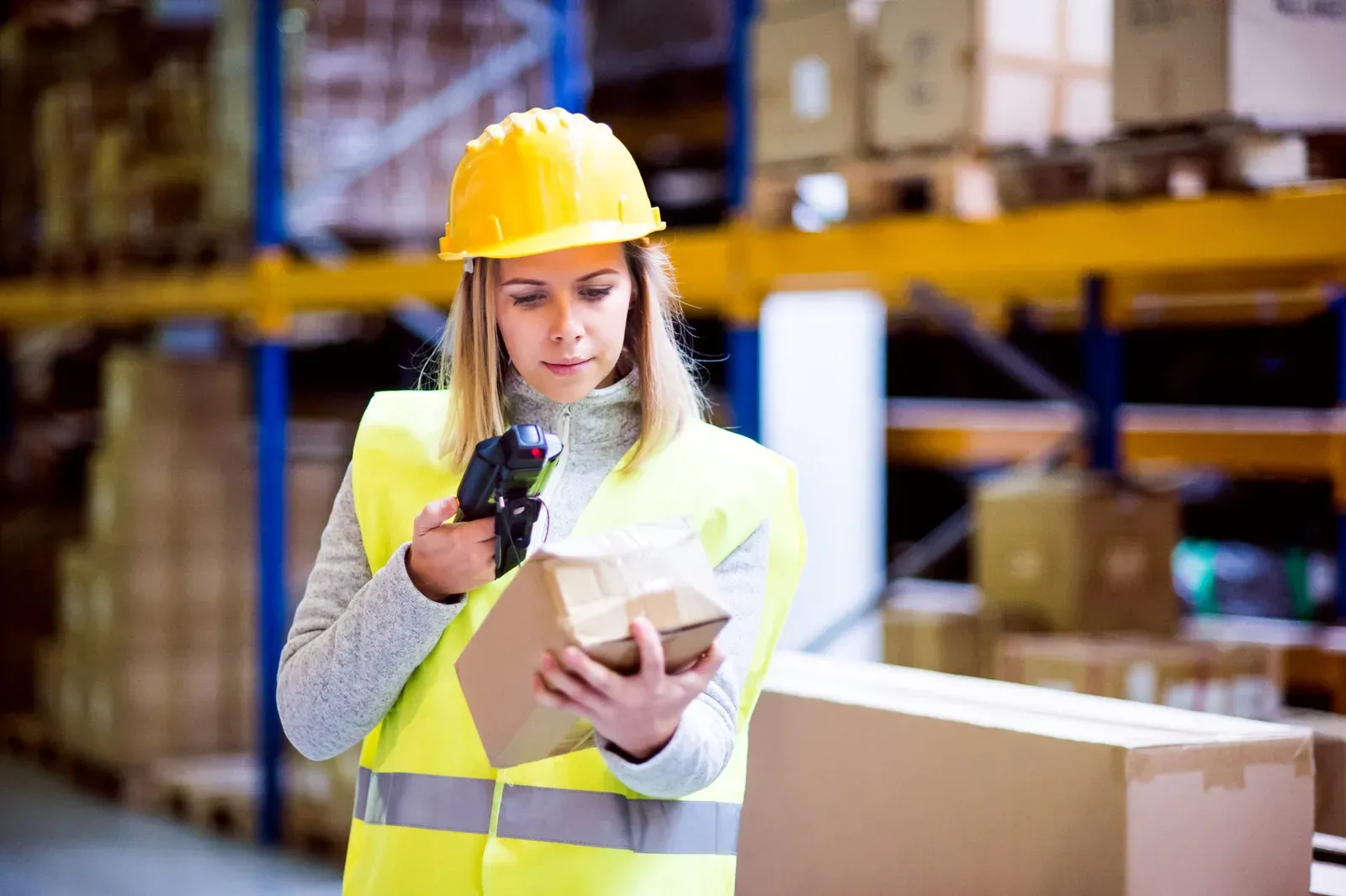 A warehouse colleague collecting a scanner from a connected eLocker asset locker