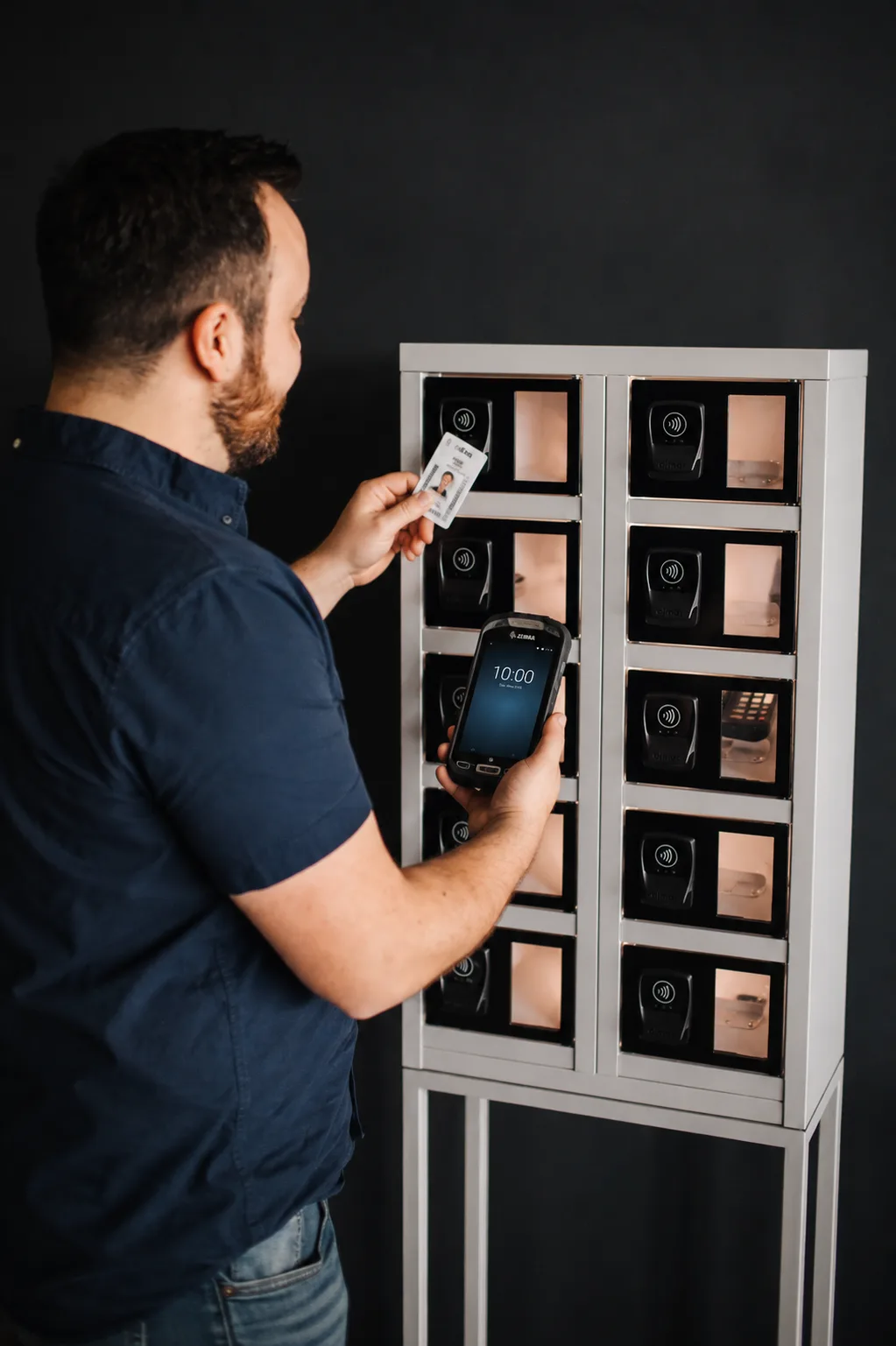 Warehouse operative scanning a device back in at return
