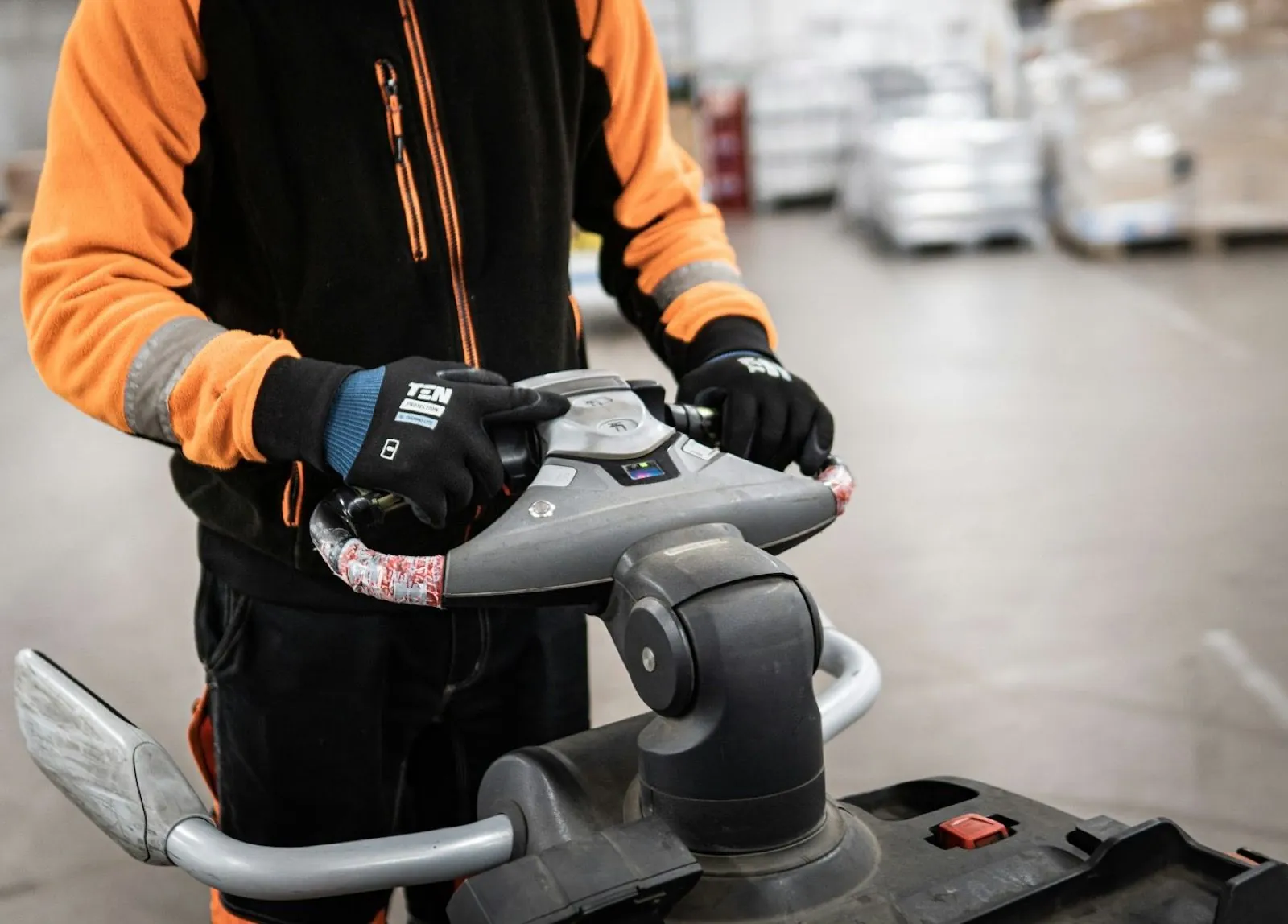 Warehouse operative using a handheld scanner on the floor